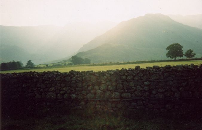 hills and a stone wall in evening light