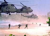 helicopters depositing marines on a beach
